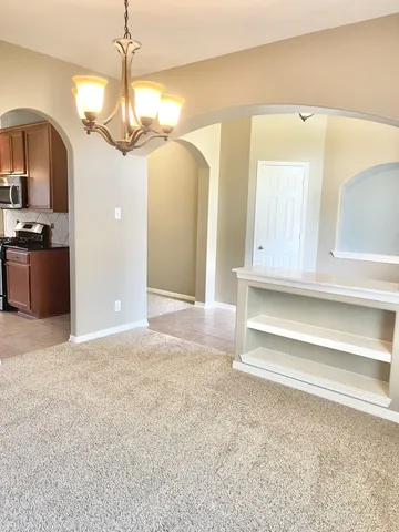 a view of a livingroom with a dishwasher cabinets and a kitchen counter top space