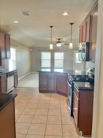 a kitchen with a sink and chandelier