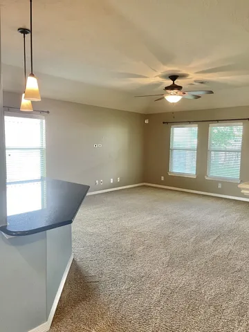 an empty room with a ceiling fan and fan