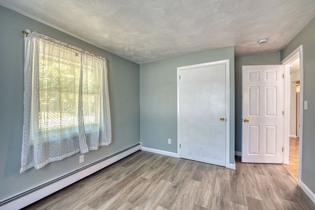 81 Errol Road Brockton, MA 02302 - Photo 12 of 31 a view of an empty room with wooden floor and a window