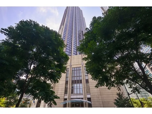 a view of a tall building with a tree in front of it