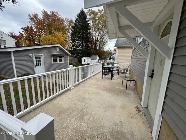 a balcony with wooden floor and fence
