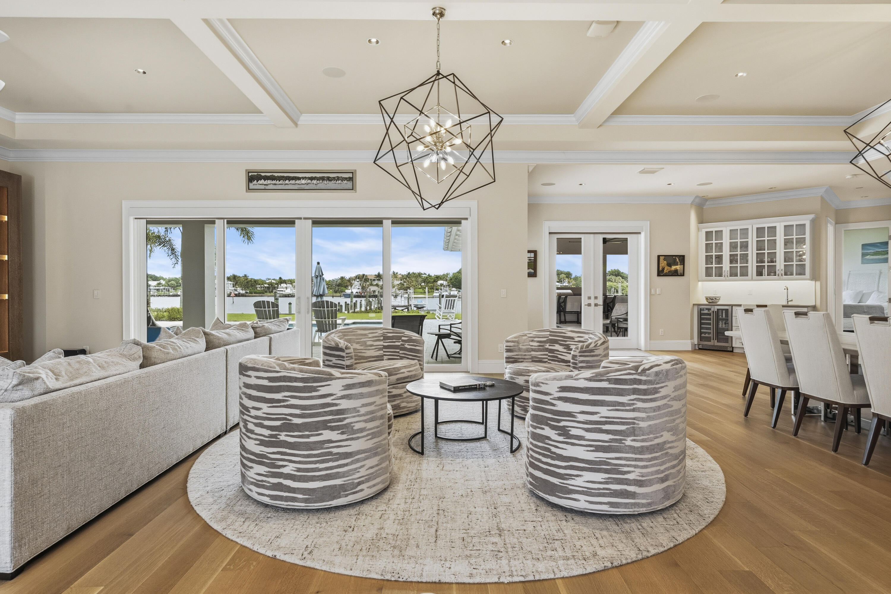 3973 Southeast Topsail Court Stuart, FL 34997 - Photo 27 of 38 a dining room with furniture wooden floor and a chandelier