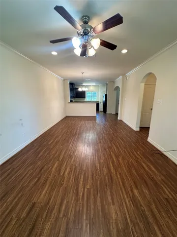 a view of an empty room and wooden floor