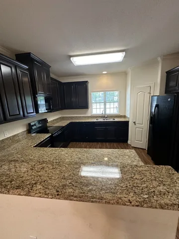 a kitchen with a refrigerator and a sink