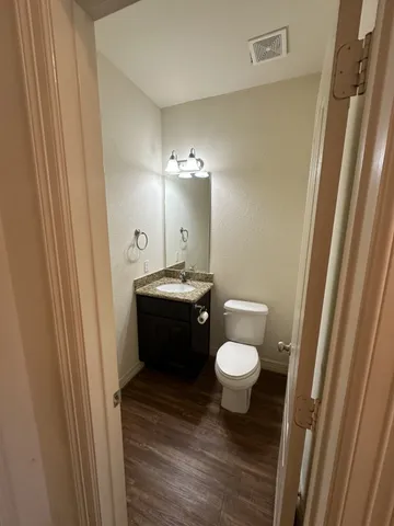 a bathroom with a sink a toilet a mirror and vanity