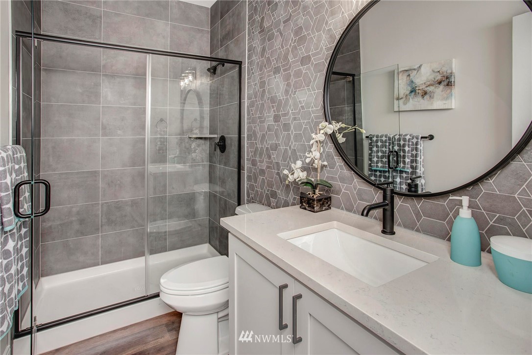 22212 17th Avenue West, Unit 5 Bothell, WA 98021 - Photo 21 of 37 a bathroom with a sink a toilet and shower