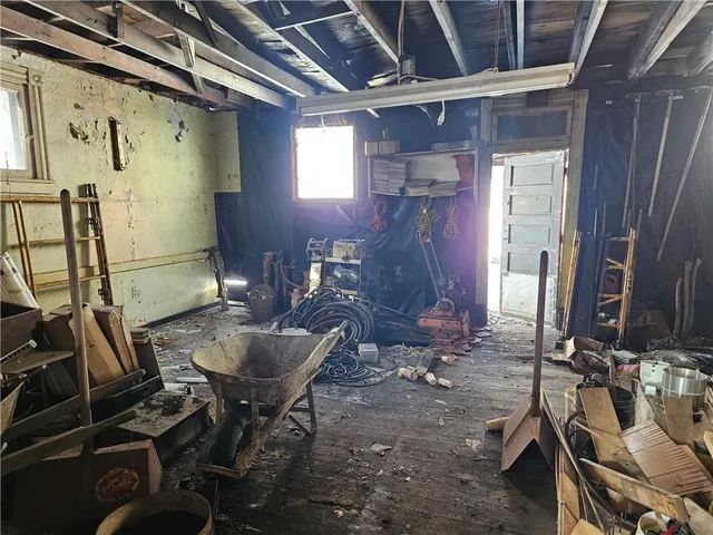 a room with table chairs and appliances