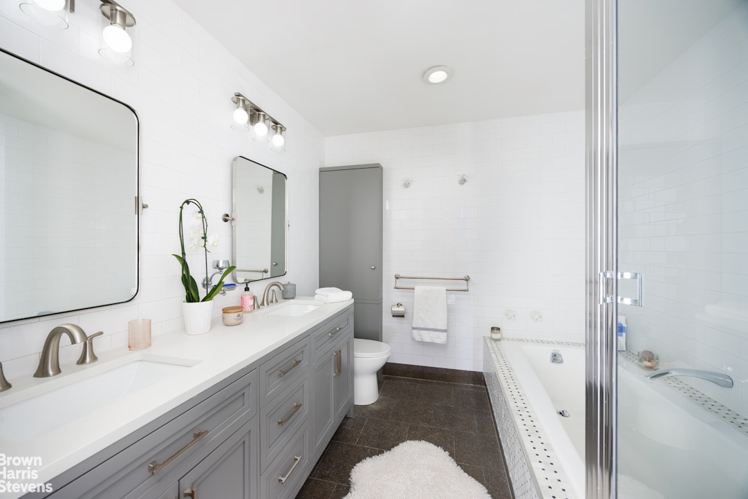 40 West 17th Street, Unit 12A Manhattan, NY 10011 - Photo 10 of 22 a bathroom with a sink a toilet and shower