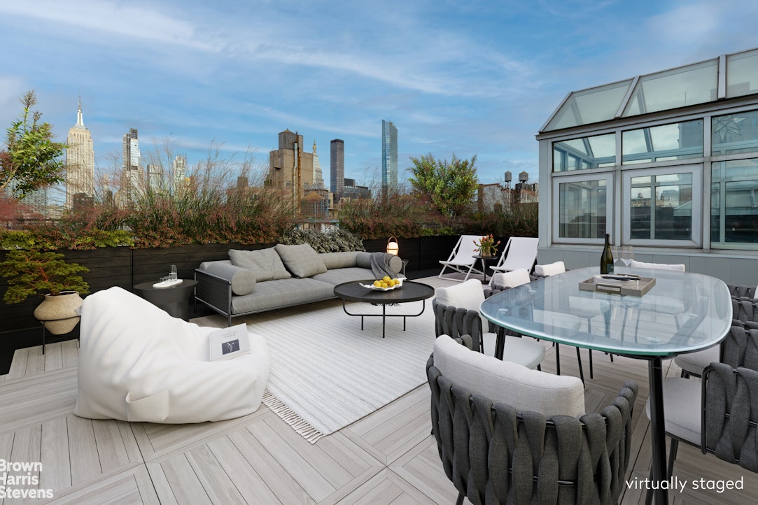 40 West 17th Street, Unit 12A Manhattan, NY 10011 - Photo 16 of 22 a view of a patio with couches table and chairs and potted plants with wooden floor and fence