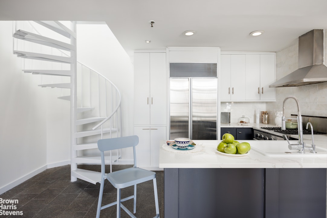40 West 17th Street, Unit 12A Manhattan, NY 10011 - Photo 2 of 22 a kitchen with a sink cabinets and wooden floor