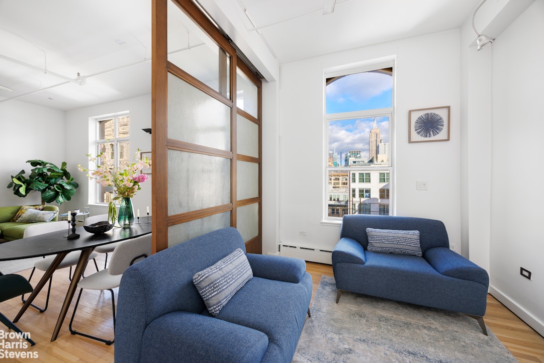 40 West 17th Street, Unit 12A Manhattan, NY 10011 - Photo 8 of 22 a living room with furniture and a potted plant