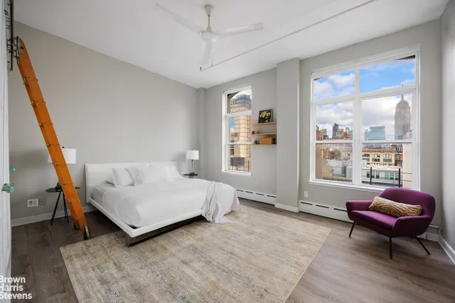 a bedroom with a bed window and couch