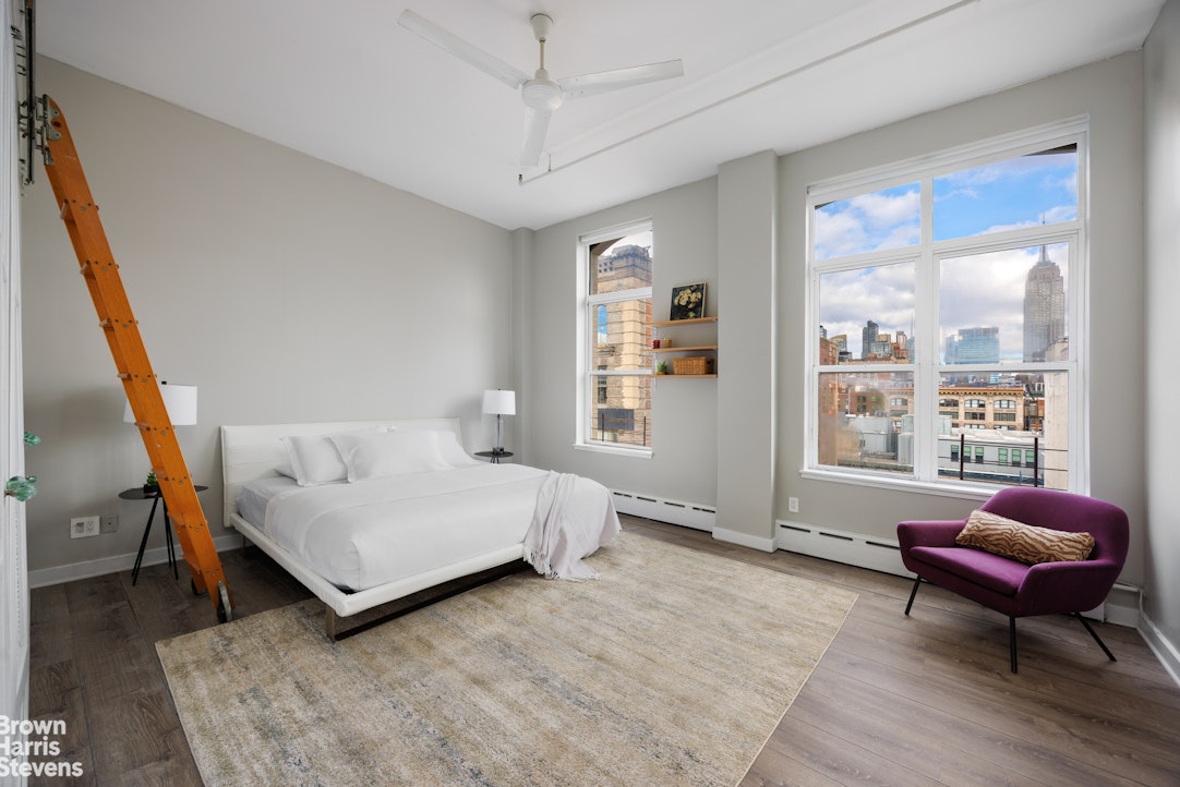40 West 17th Street, Unit 12A Manhattan, NY 10011 - Photo 9 of 22 a bedroom with a bed window and couch