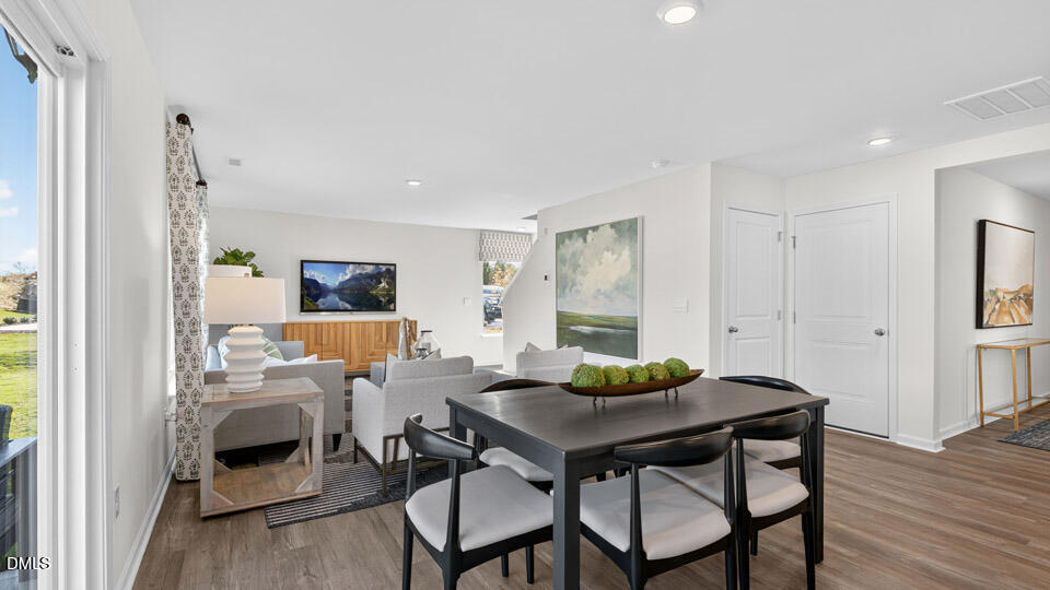 113 Ross Drive Stem, NC 27581 - Photo 13 of 42 a view of a dining room with furniture and wooden floor