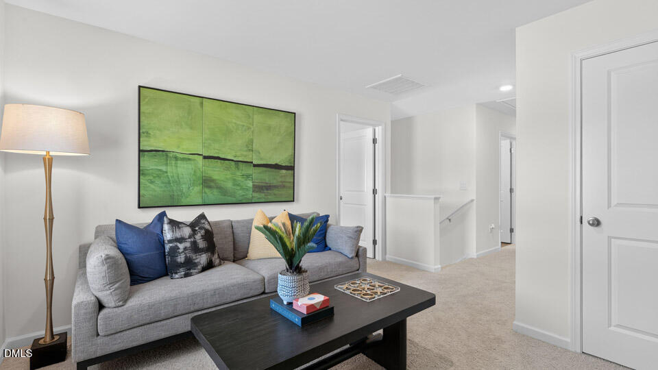 113 Ross Drive Stem, NC 27581 - Photo 24 of 42 a living room with furniture and a floor to ceiling window