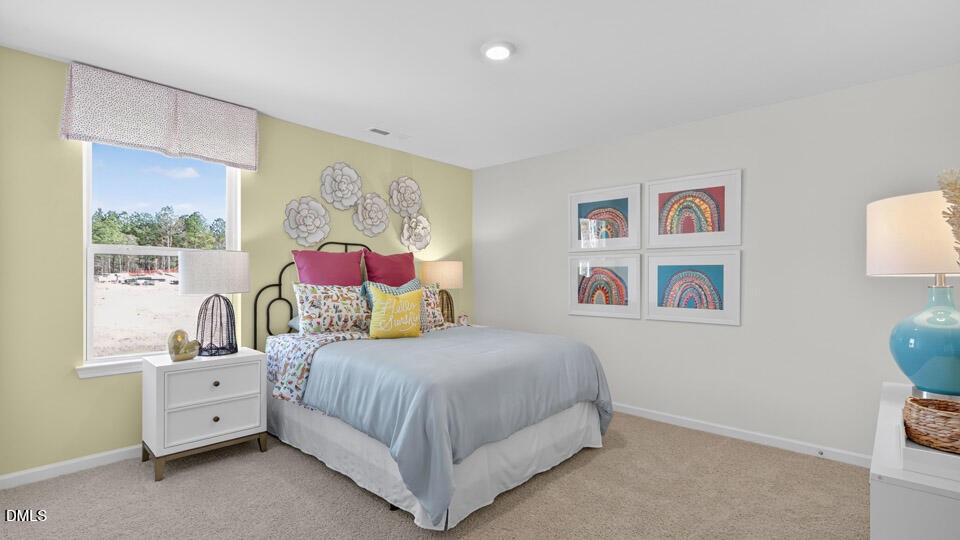 113 Ross Drive Stem, NC 27581 - Photo 34 of 42 a bedroom with a bed and a painting on the wall