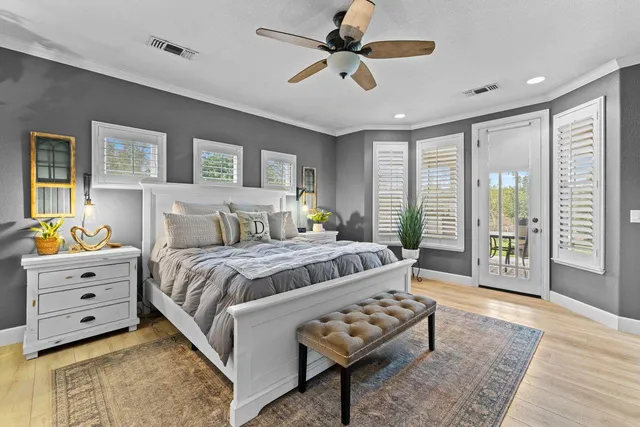 a spacious bedroom with a bed and a flat screen tv