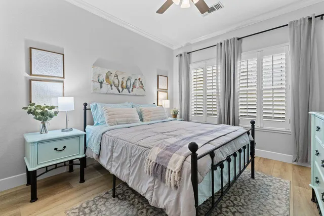 a bedroom with a bed and a painting on the wall