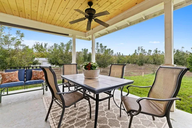 an aerial view of a house with a yard and lake view