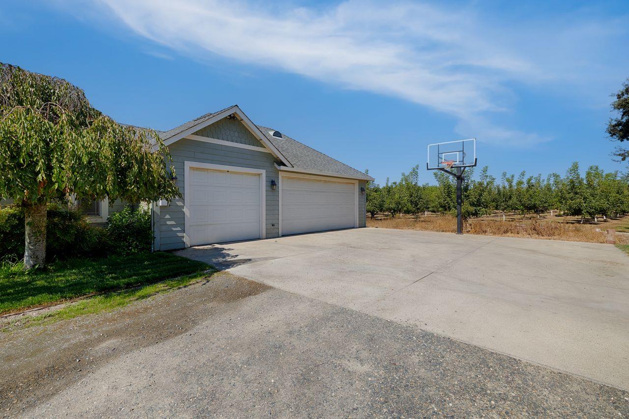 3302 Bear River Drive Rio Oso, CA 95674 - Photo 34 of 50 a view of yellow house with a yard and large trees
