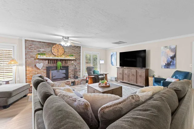 a living room with furniture fireplace and window