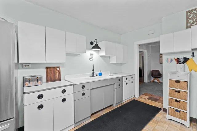 a kitchen that has a table chairs and cabinets