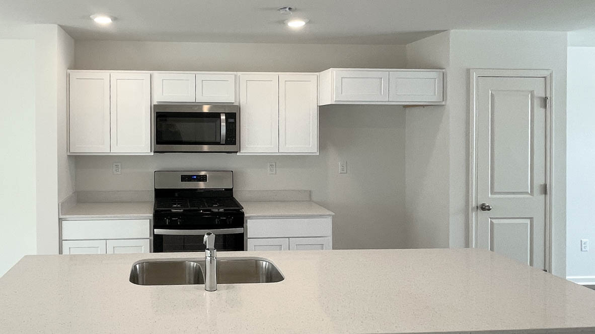 6530 Linden Trail, Unit C Wonder Lake, IL 60097 - Photo 6 of 27 a kitchen with a sink a stove and refrigerator