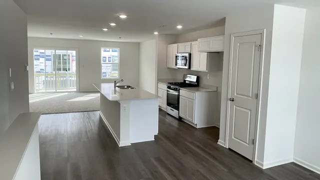 a kitchen with sink and refrigerator