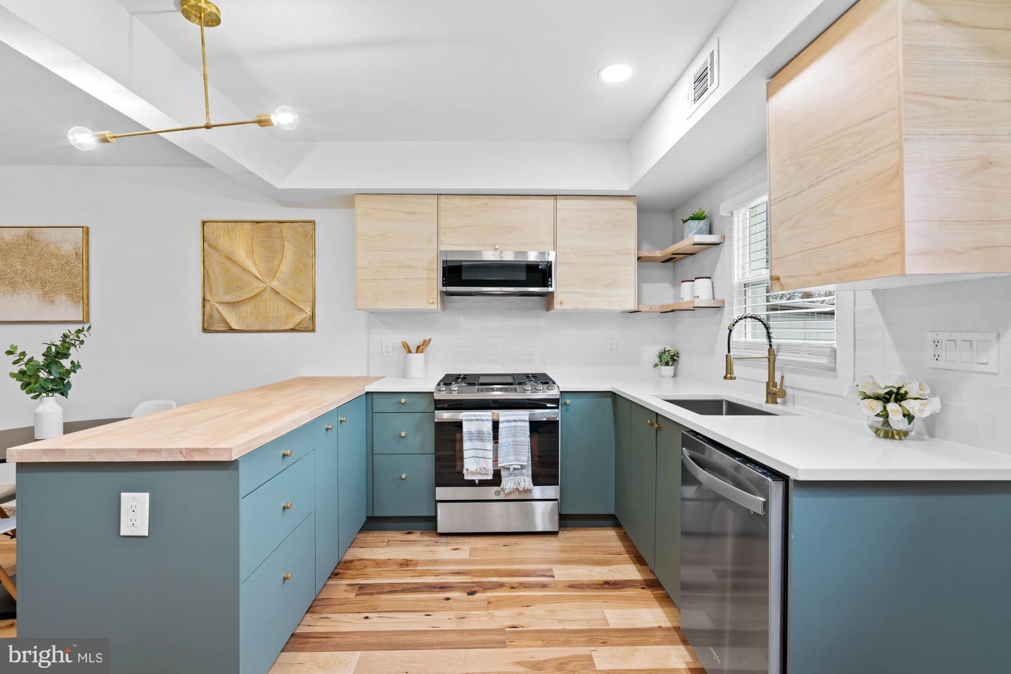 1458 Howard Road Southeast Washington, DC 20020 - Photo 13 of 49 a kitchen with stainless steel appliances granite countertop a sink stove and refrigerator