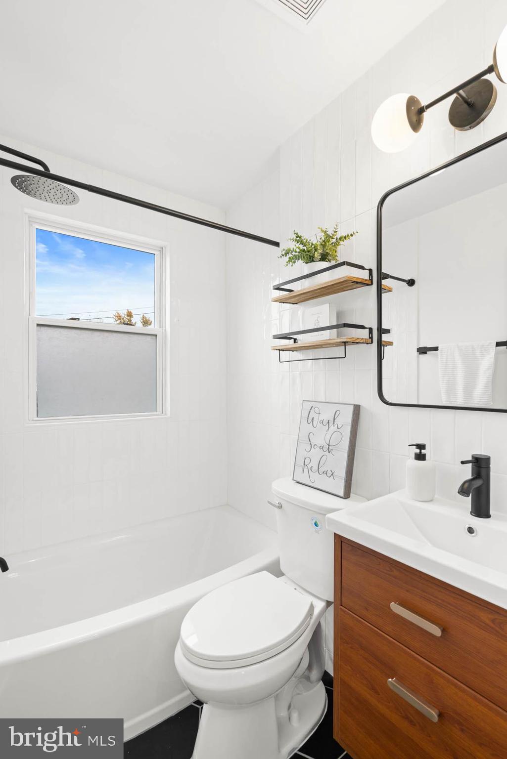 1458 Howard Road Southeast Washington, DC 20020 - Photo 29 of 49 a bathroom with a sink a toilet and shower