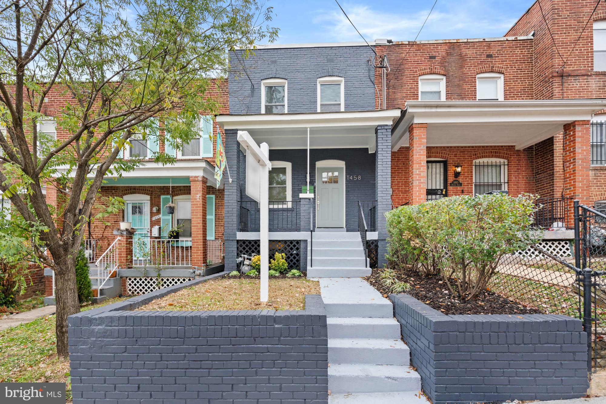 1458 Howard Road Southeast Washington, DC 20020 - Photo 3 of 49 front view of a house with a porch and a yard