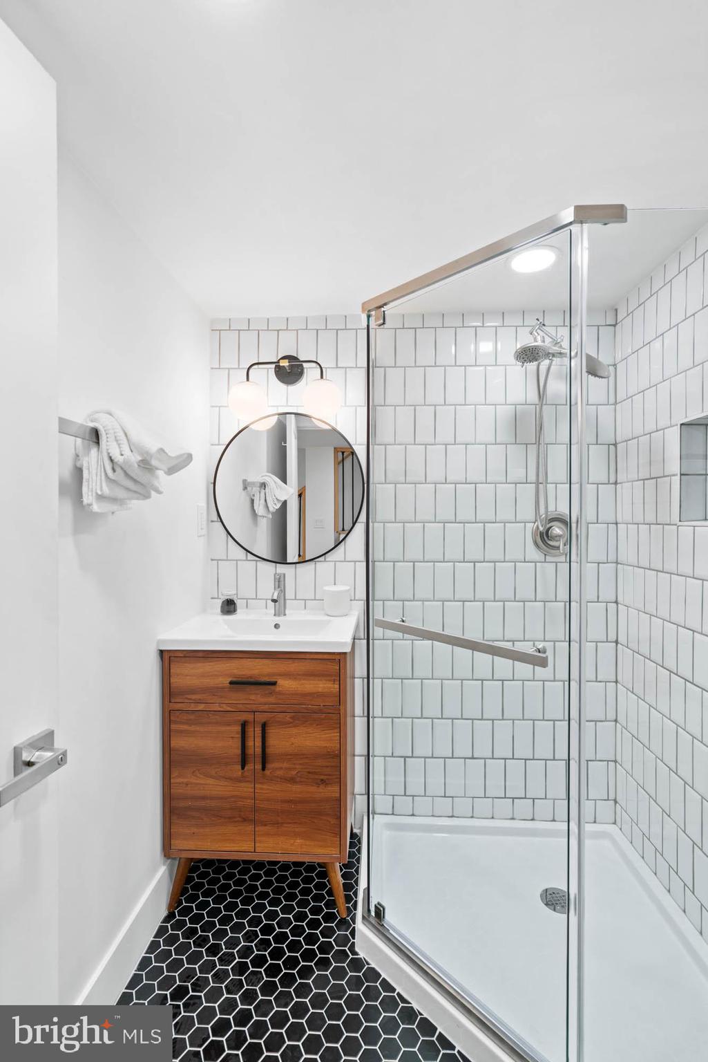 1458 Howard Road Southeast Washington, DC 20020 - Photo 37 of 49 a bathroom with a sink a mirror and a shower