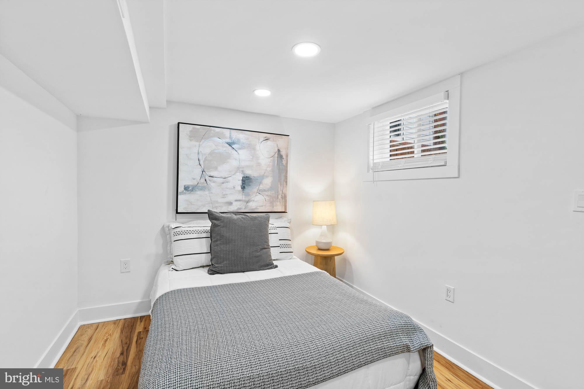 1458 Howard Road Southeast Washington, DC 20020 - Photo 40 of 49 a bedroom with a bed and painting on the wall