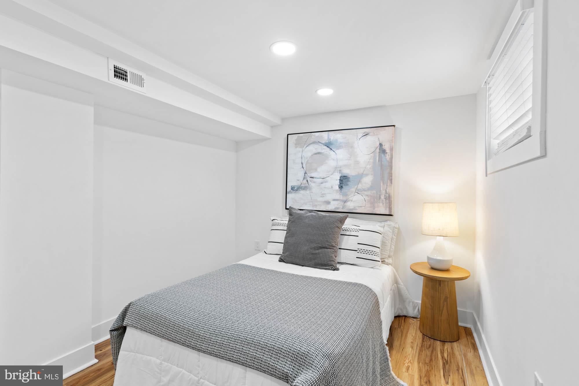 1458 Howard Road Southeast Washington, DC 20020 - Photo 41 of 49 a bedroom with a bed and a painting on the wall