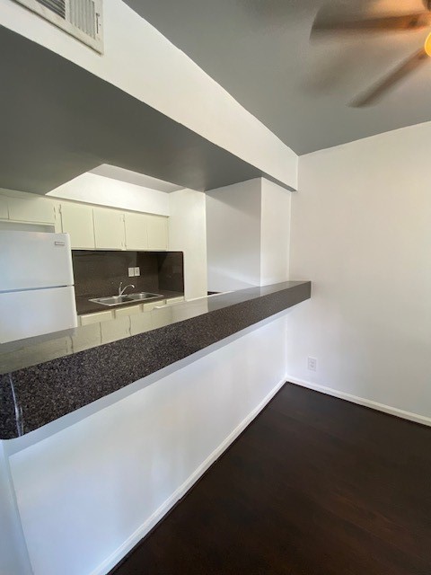 4701 Bell Street, Unit 10 Houston, TX 77023 - Photo 3 of 19 a kitchen with a sink a microwave and cabinets