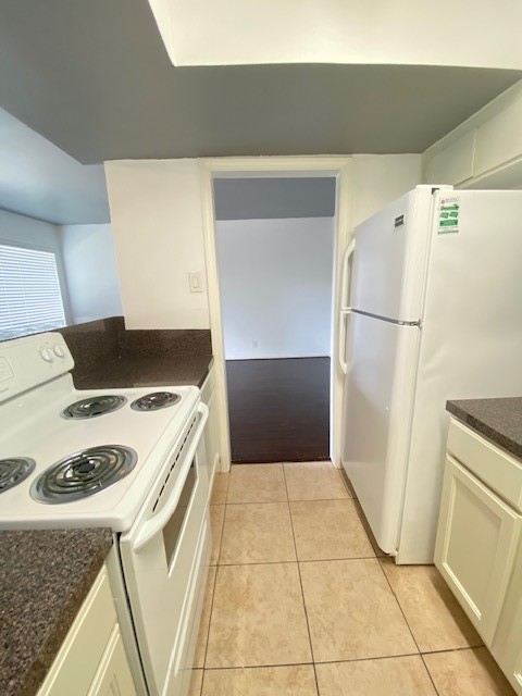 4701 Bell Street, Unit 10 Houston, TX 77023 - Photo 8 of 19 a kitchen with a stove top oven and cabinets