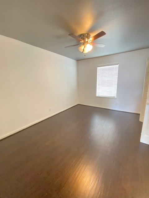 4701 Bell Street, Unit 10 Houston, TX 77023 - Photo 9 of 19 an empty room with a chandelier fan and windows