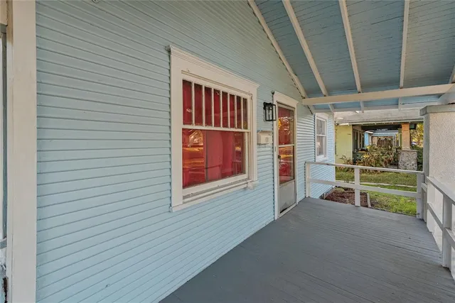 a view of hallway with fireplace furniture and a flat screen tv
