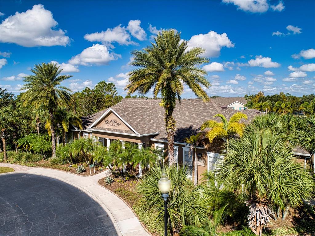 8932 Manor Loop, Unit 104 Lakewood Ranch, FL 34202 - Photo 16 of 35 a view of a house with a yard and garden