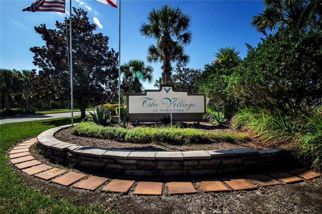 8932 Manor Loop, Unit 104 Lakewood Ranch, FL 34202 - Photo 22 of 35 a front view of a house with a garden