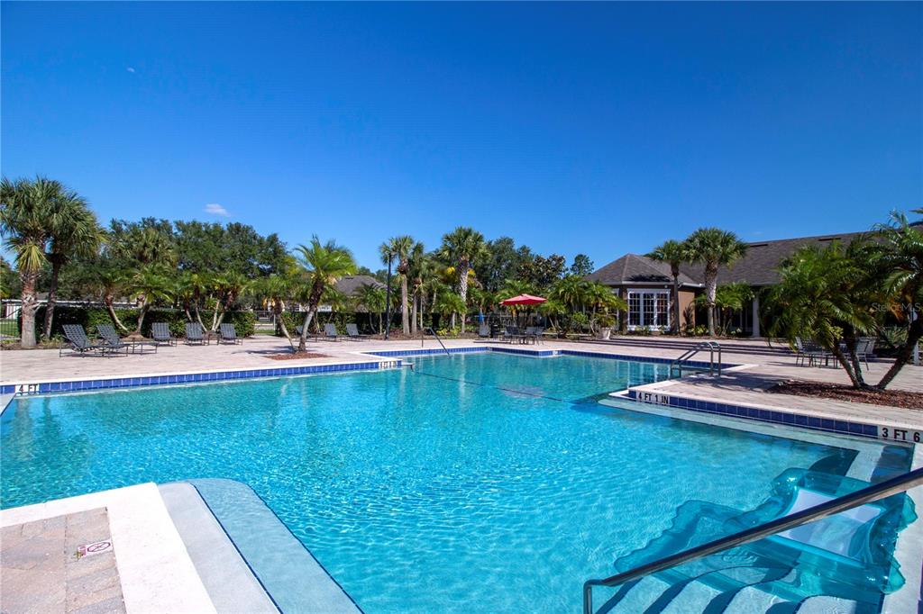 8932 Manor Loop, Unit 104 Lakewood Ranch, FL 34202 - Photo 30 of 35 a view of a swimming pool with an outdoor seating and house