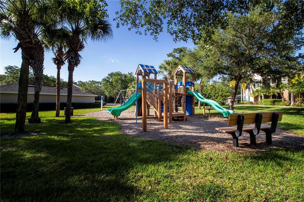 8932 Manor Loop, Unit 104 Lakewood Ranch, FL 34202 - Photo 34 of 35 a view of a park with swings and a table