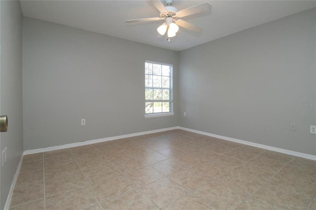 8932 Manor Loop, Unit 104 Lakewood Ranch, FL 34202 - Photo 8 of 35 an empty room with a window and a fan