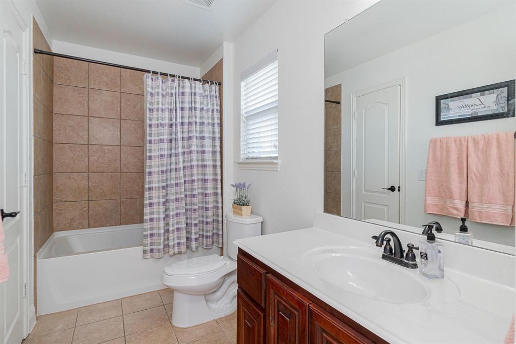 4210 Magnolia Road Melissa, TX 75454 - Photo 19 of 22 White vanity with a single basin sink and dark-finish fixtures