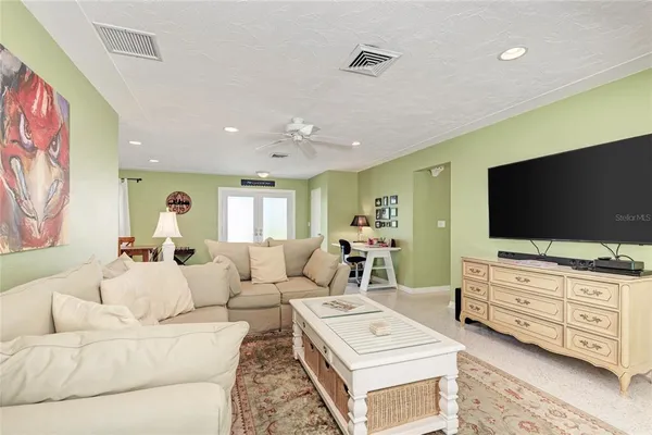 a kitchen with a dining table chairs cabinets and stainless steel appliances