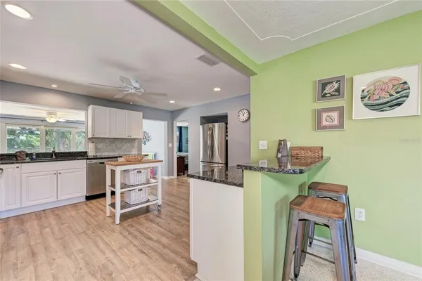 a kitchen with stainless steel appliances and white cabinets
