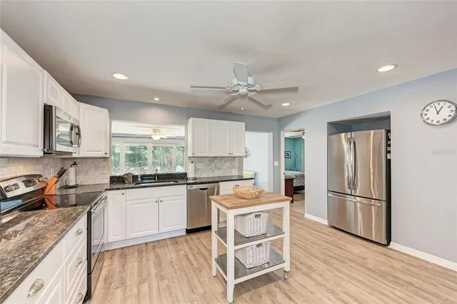 a kitchen with a stove a sink and a refrigerator
