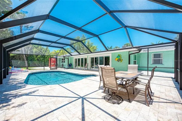 a view of a patio with table and chairs under an umbrella