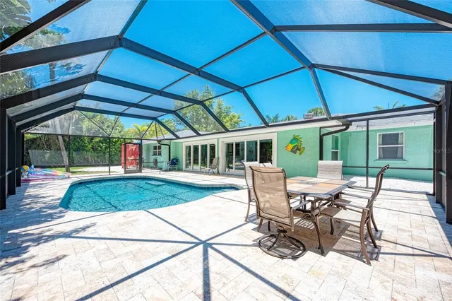 a view of a patio with table and chairs under an umbrella